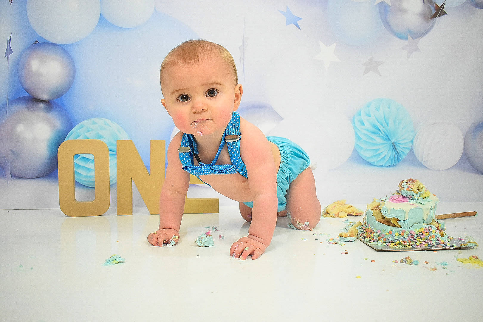 Bowden is registered to the contest to win money with this photo: aqua, azure, baby, baby_toddler_clothing, child, event, flash_photography, flooring, font, fun, happy, leisure, party_supply, person, product, room, sitting, sleeve, t_shirt, toddler