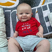 Easton joined the competition — help win amazing prizes! baby, infant, smiling, red_shirt, sitting, pillow, blanket, cute, happy, indoor, child, young, celebration, holiday, footwear, sock, clothing, face, portrait, couch