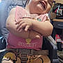 baby, child, smile, laugh, high_chair, bib, pink_clothing, winnie_the_pooh, pants, barefoot, indoor, kitchen, wood_paneling, clock, utensils, seatbelt, happy, cute, person, furniture