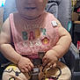baby, child, high_chair, bib, smiling, indoors, wooden_wall, pants, winnie_the_pooh, cute, happy, infant, seatbelt, clothing, person, foot, hand, face, portrait, home
