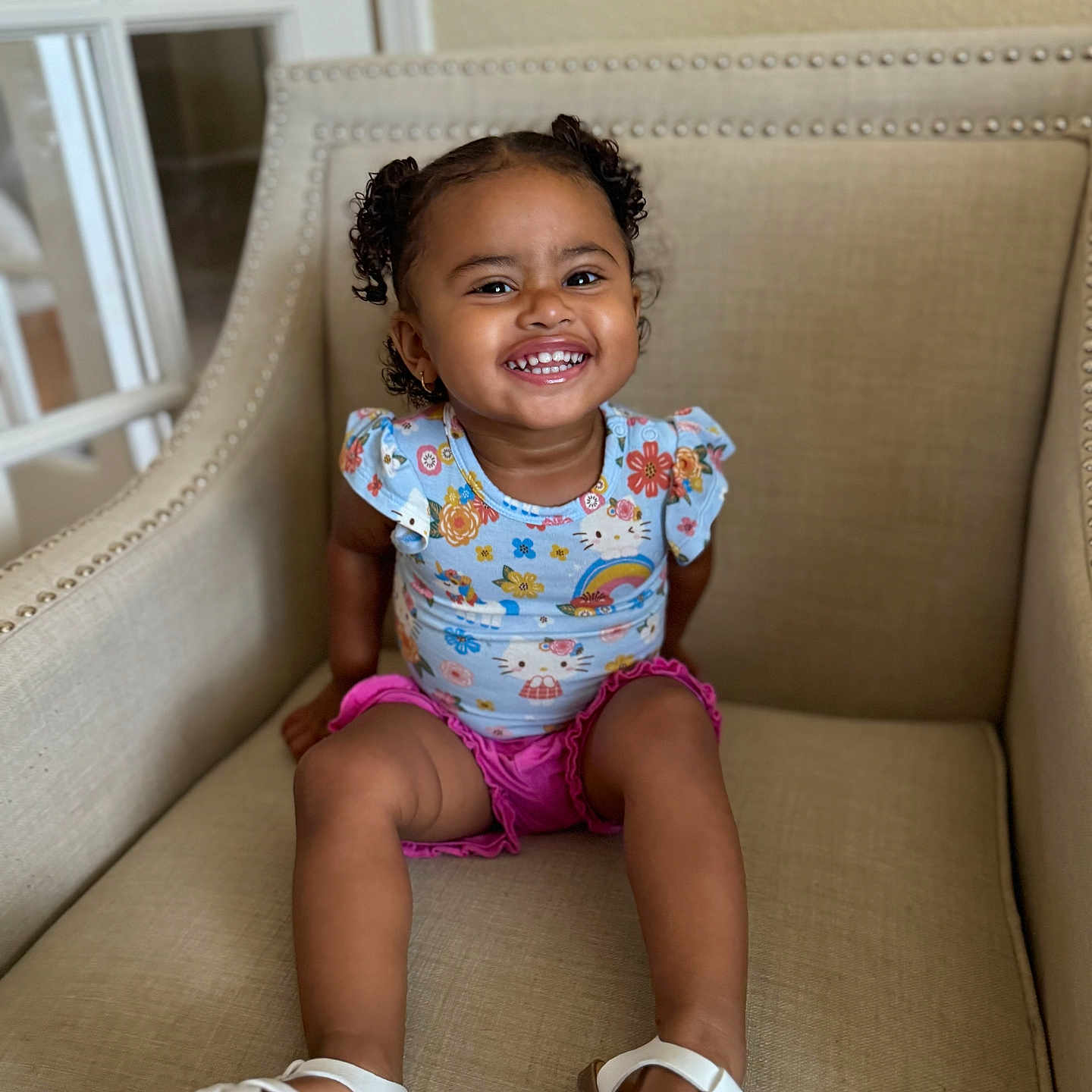 Zoe joined the competition — help win amazing prizes! baby, babylaughing, child, clothing, couch, face, female, footwear, girl, happy, head, person, photography, portrait, sandal, shoe, shorts, sitting, sleeve, smile