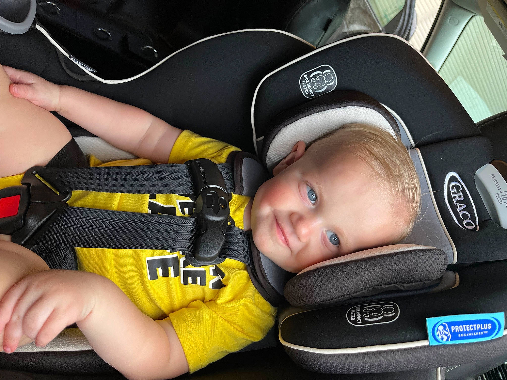 Ashton is registered to the contest to win money with this photo: auto_part, baby, baby_carriage, baby_in_car_seat, baby_products, baby_safety, baby_toddler_clothing, car_seat, cheek, child, comfort, fashion_accessory, fun, hat, hearing, joy, person, personal_protective_equipment, product, sports_gear