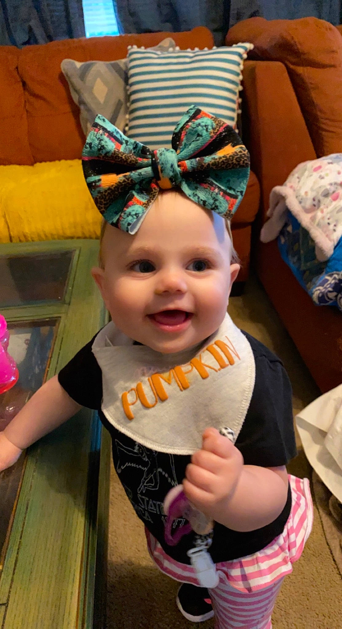 Harlyn is registered to the contest to win money with this photo: baby, baby_toddler_clothing, child, costume, costume_hat, event, fashion_accessory, fun, happy, hat, headgear, headpiece, headwear, joy, party_supply, person, pink, purple, room, smile
