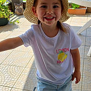 Elena participe au concours pour gagner de l'argent avec cette photo : child, cute, daylight, footwear, garden, happy, hat, kid, lemon_graphic, outdoor, patio, person, plants, sandals, skirt, smiling, summer, sunhat, tiles, tshirt