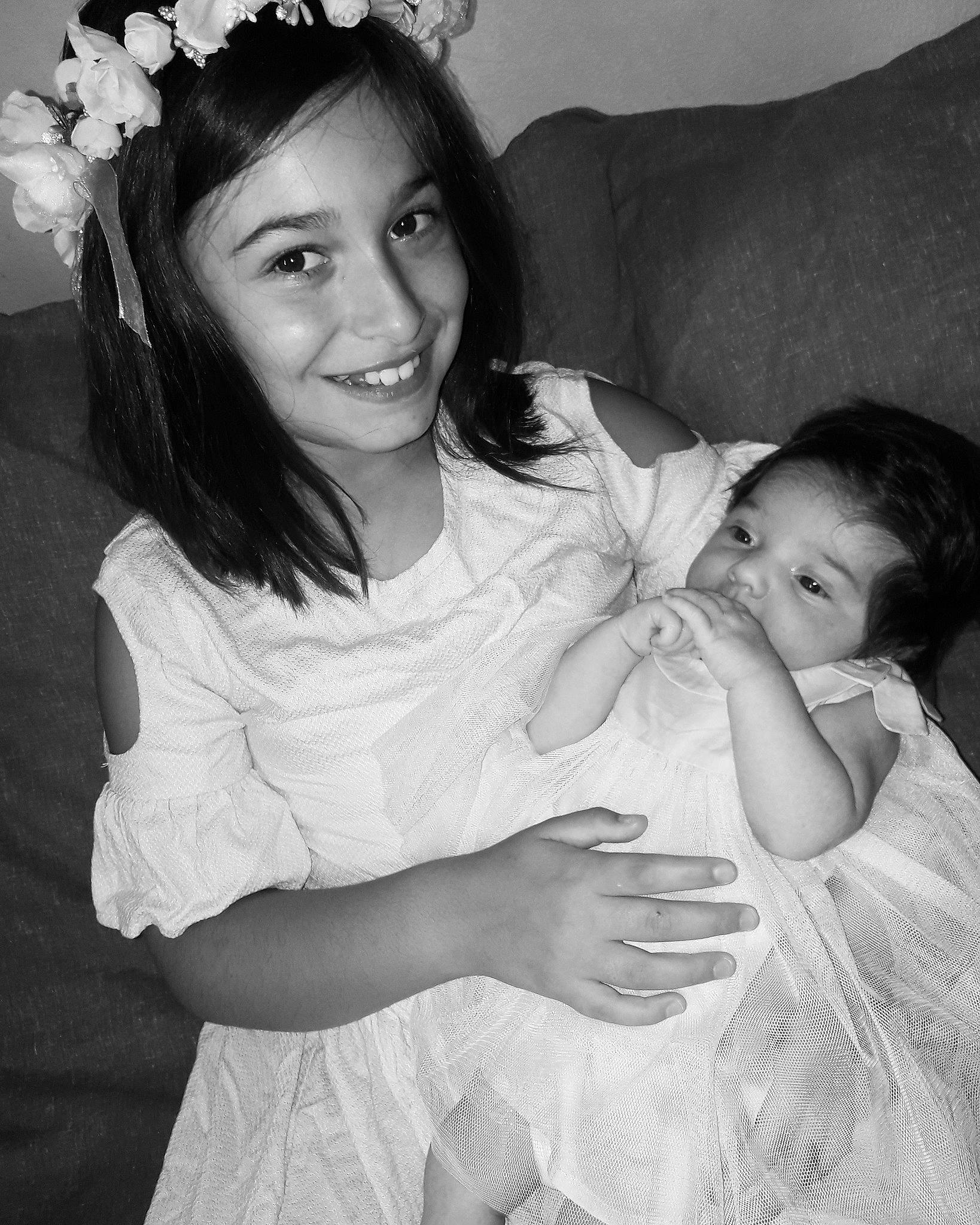 Nora participe au concours pour gagner de l'argent avec cette photo : baby, birth, black_and_white, child, fun, gesture, hair_accessory, happy, headpiece, iris, joy, long_hair, monochrome, monochrome_photography, people, person, photograph, photography, portrait, smile