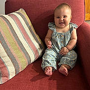 Brynlee is registered to the contest to win money with this photo: baby, child, smiling, sitting, couch, pillow, indoor, clothing, foot, face, happy, furniture, infant, person, cute, home, relaxed, comfort, portrait, young