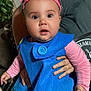 baby, blue_outfit, button, child, costume, couch, curious, cute, expression, face, hand, indoor, living_room, person, pink_headband, pink_sleeves, plant, seated, surprised, toddler