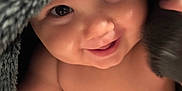Brynlee is registered to the contest to win money with this photo: baby, smiling, close_up, blanket, skin, face, eyes, infant, cute, child, happy, soft_texture, warm_light, cheeks, expression, adorable, indoors, naked_torso, young, portrait