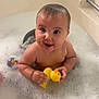Brynlee is registered to the contest to win money with this photo: baby, bathtub, bubbles, rubber_duck, bath_toys, child, foam, happy, smile, water, skin, bathroom, cute, playful, infant, sitting, wet, toy, person, young
