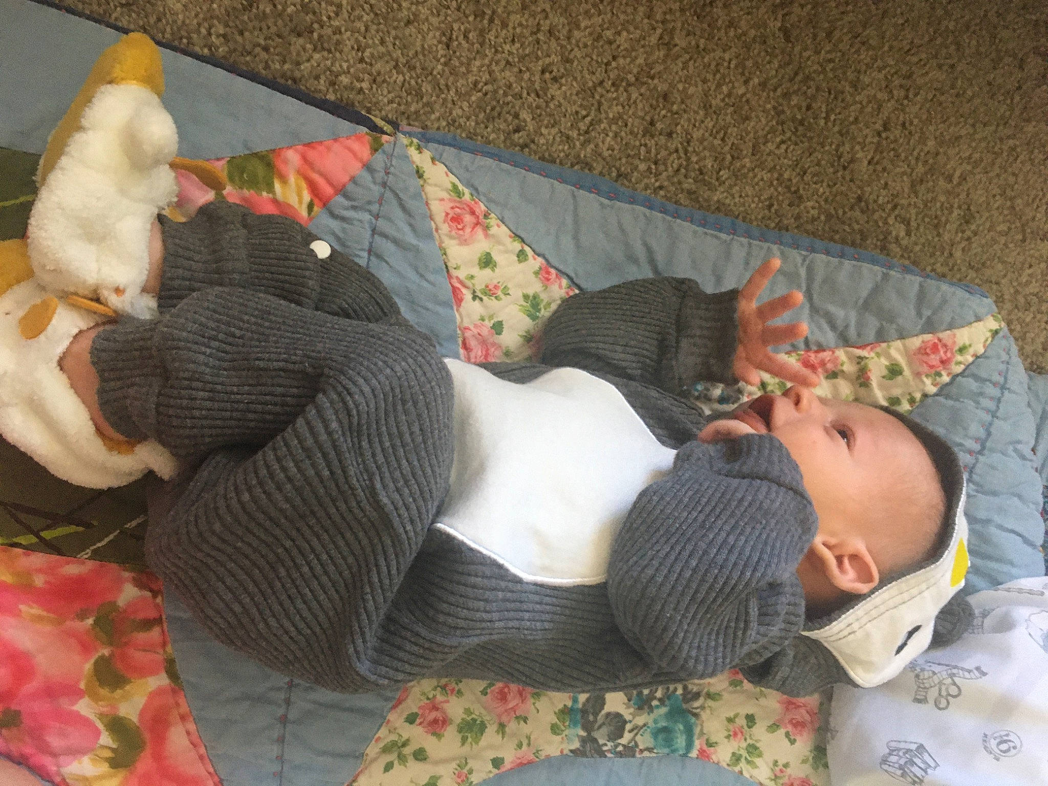 Grayson is registered to the contest to win money with this photo: baby, baby_products, bed_sheet, bedding, bedtime, child, comfort, human_leg, lap, linens, mammal, nap, pattern, person, room, sleep, sock, stuffed_toy, textile, thigh