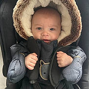 Elijah participe au concours pour gagner de l'argent avec cette photo : baby, blue_eyes, car_seat, child, cold_weather, cute, expression, fur_hood, hands, headwear, indoors, infant, jacket, portrait, seatbelt, snug, soft_texture, tiny, warm_clothing, winter_coat