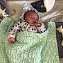 baby, sleeping, hoodie, mickey_mouse, blanket, knitted, crib, toy, nursery, soft_toy, infant, cute, resting, child, cozy, bed, hand, peaceful, indoors, warm