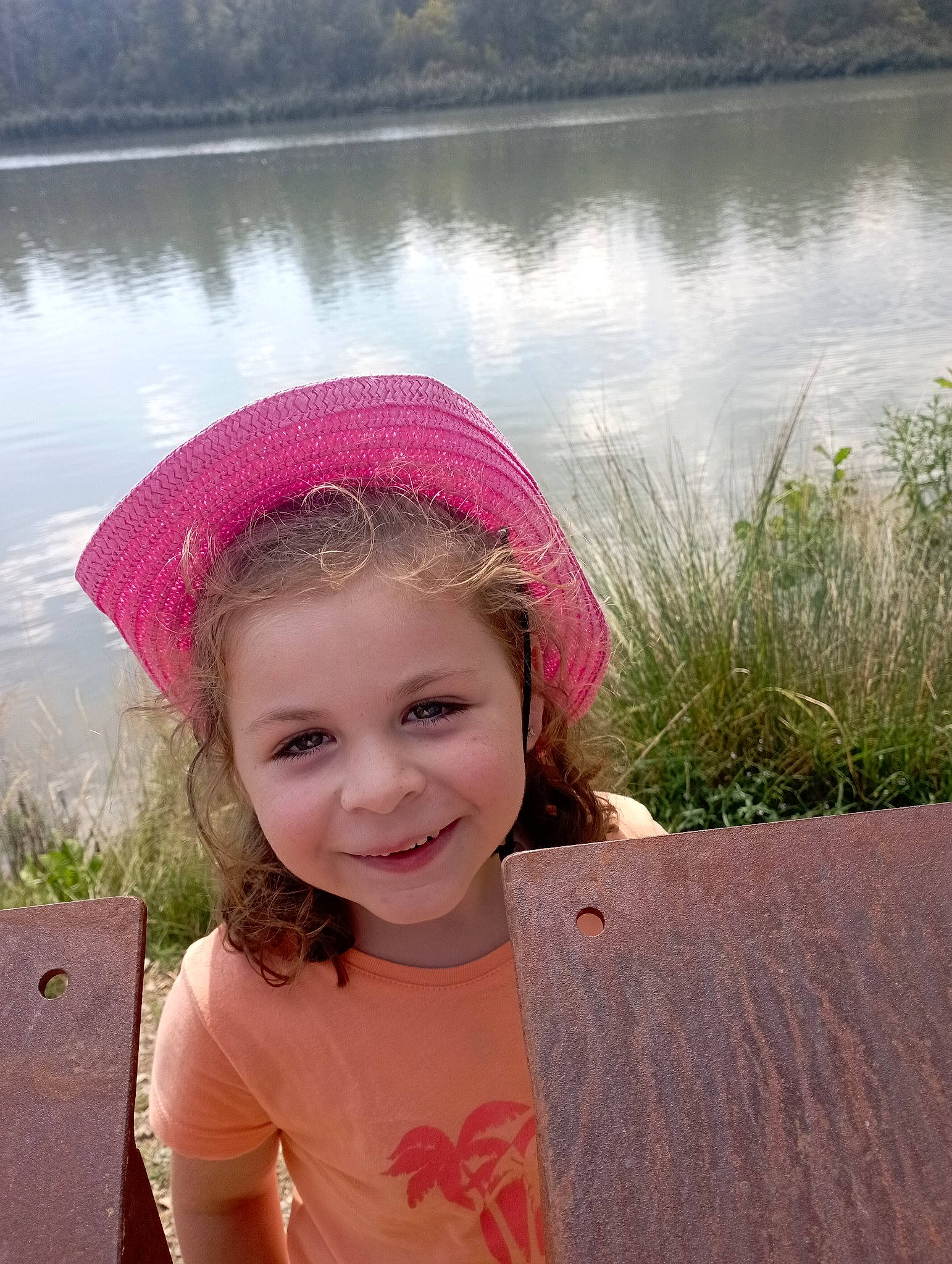 Ashley participe au concours pour gagner de l'argent avec cette photo : cap, eye, fun, grass, happy, head, headgear, joy, lake, lip, magenta, morning, people_in_nature, person, pink, plant, smile, standing, summer, toddler