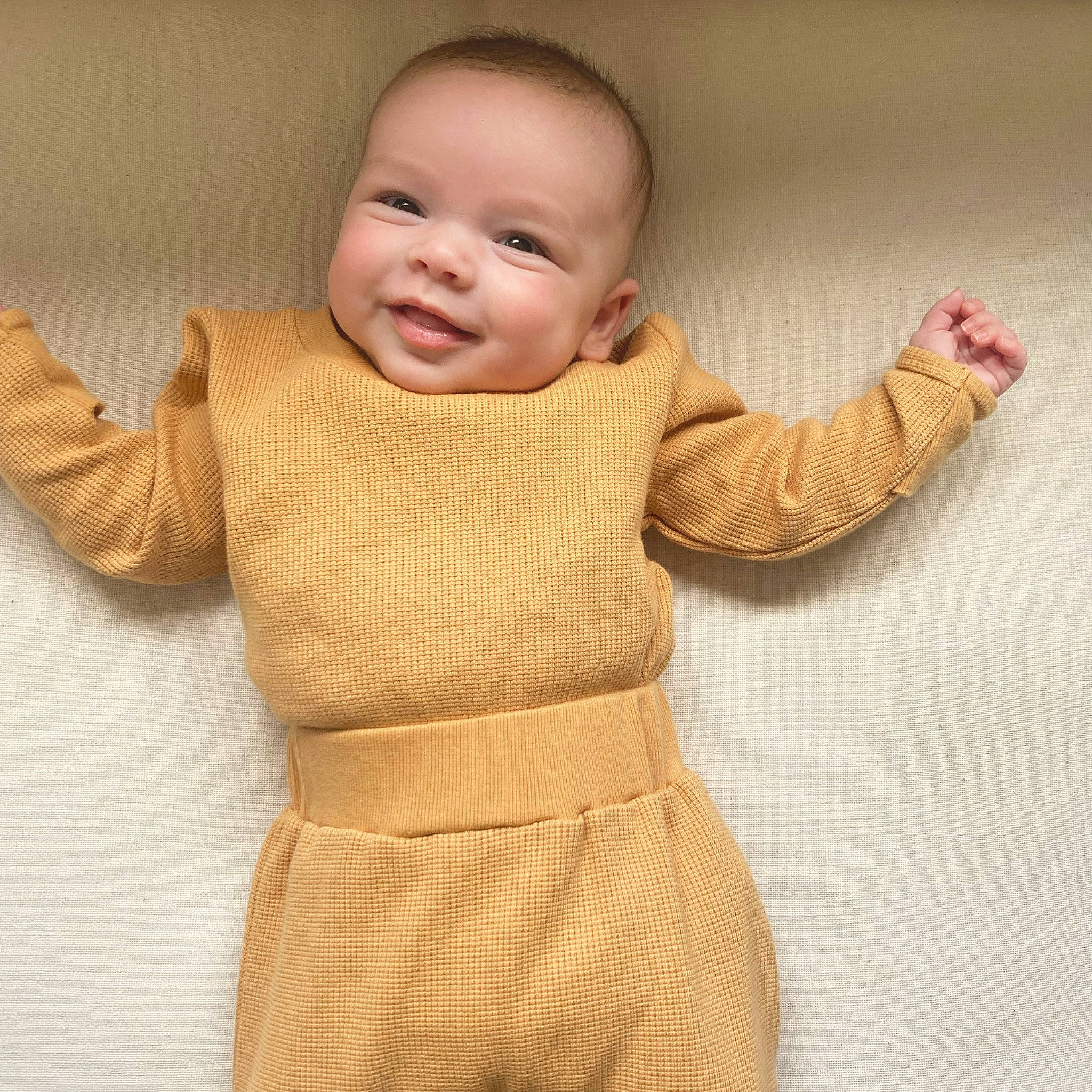 Alessandra joined the competition — help win amazing prizes! baby, baby_toddler_clothing, cheek, comfort, face, finger, flooring, gesture, head, human_body, joy, nose, outerwear, person, product, skin, sleeve, smile, textile, thumb