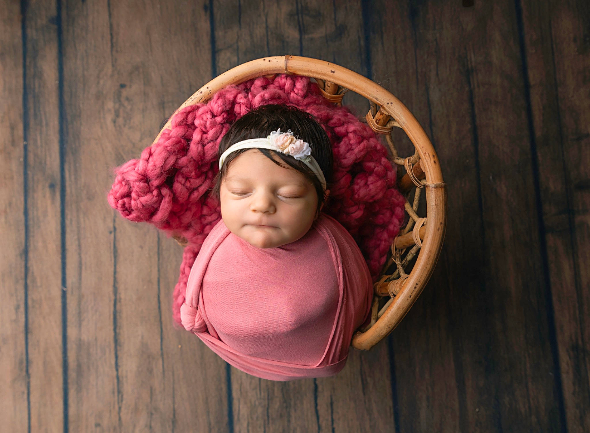 Freyja is registered to the contest to win money with this photo: art, baby, baby_products, baby_toddler_clothing, cap, child, craft, fashion_accessory, flooring, happy, headwear, knit_cap, magenta, pattern, person, pink, textile, thread, toddler, wood
