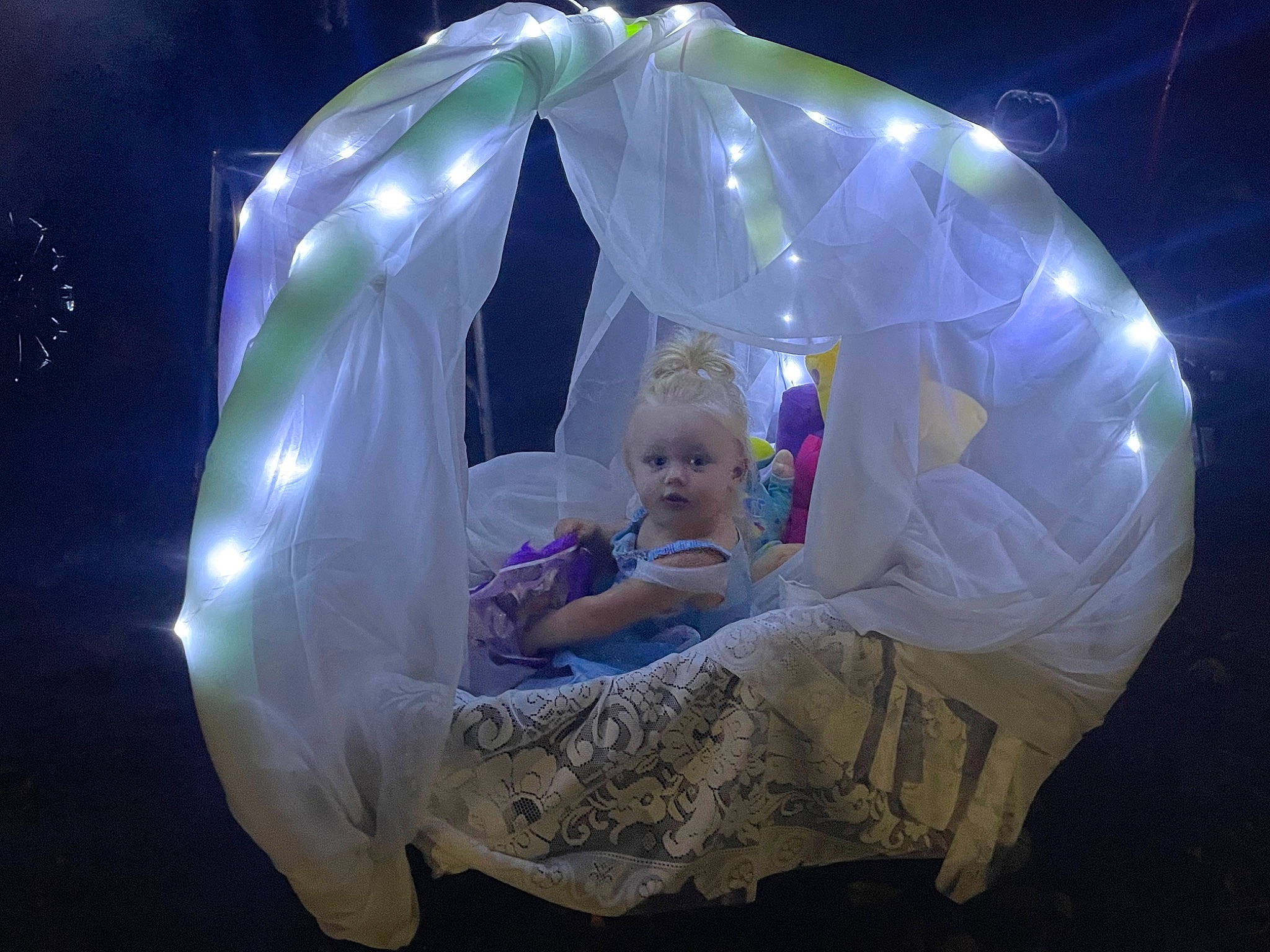 Kathryn is registered to the contest to win money with this photo: art, child, circle, darkness, electric_blue, event, fashion, flash_photography, fun, games, inflatable, leisure, magenta, night, person, purple, recreation, sitting, space, toddler