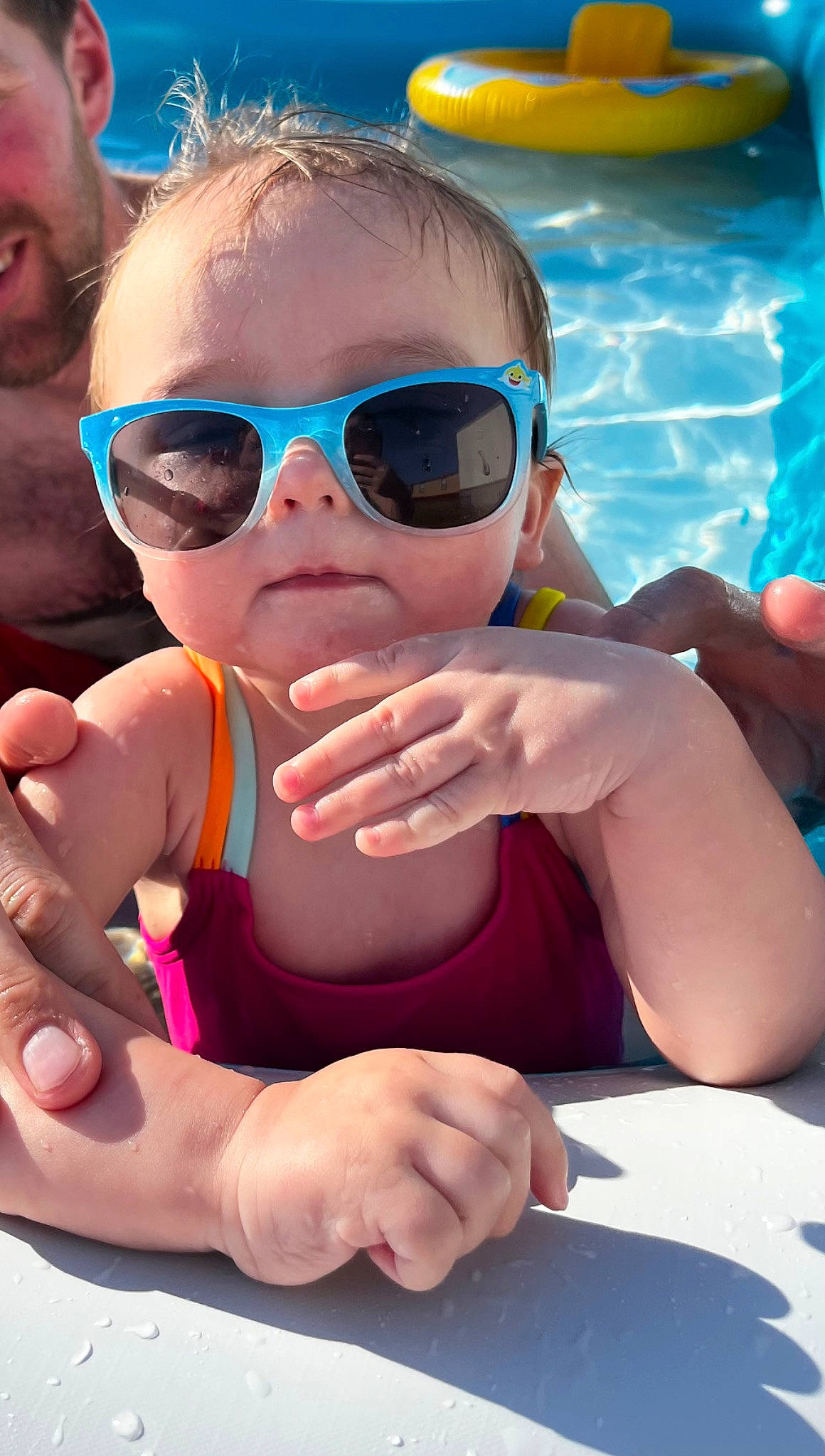 Kynlee is registered to the contest to win money with this photo: blue, cool, eyewear, face, facial_expression, finger, fun, gesture, glasses, goggles, hand, happy, head, leisure, muscle, person, pink, sunglasses, swimming_pool, vision_care