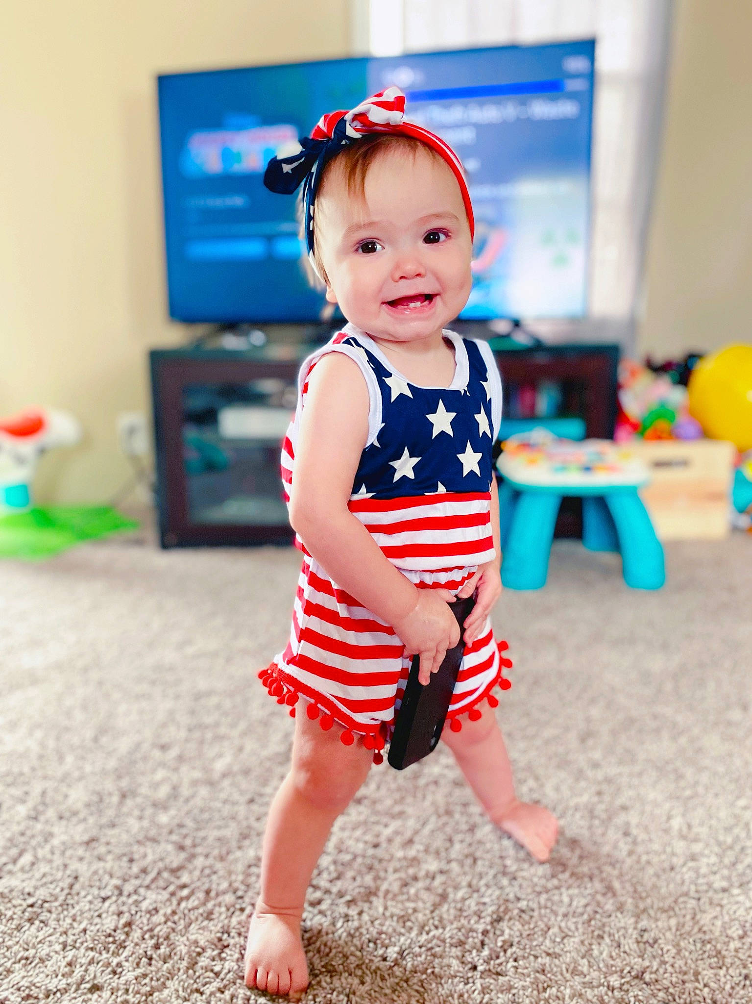 Kynlee joined the competition — help win amazing prizes! baby, baby_toddler_clothing, child, dress, electric_blue, flooring, foot, fun, happy, human_leg, joy, knee, one_piece_garment, pattern, person, skin, sleeve, smile, t_shirt, thigh