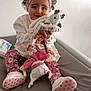 Jannah participe au concours pour gagner de l'argent avec cette photo : toddler, child, headband, pink, toy, giraffe, plush_doll, changing_table, white_shirt, floral_pants, shoes, smiling, indoors, baby_wipes, curly_hair, cute, person, soft_toys, happy, sitting