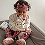 baby, baby_wipes, blanket, changing_table, child, clothing, cute, floral_pattern, footwear, headband, indoor, pacifier, person, pink, sitting, soft_toy, toddler, toy, white, young_child