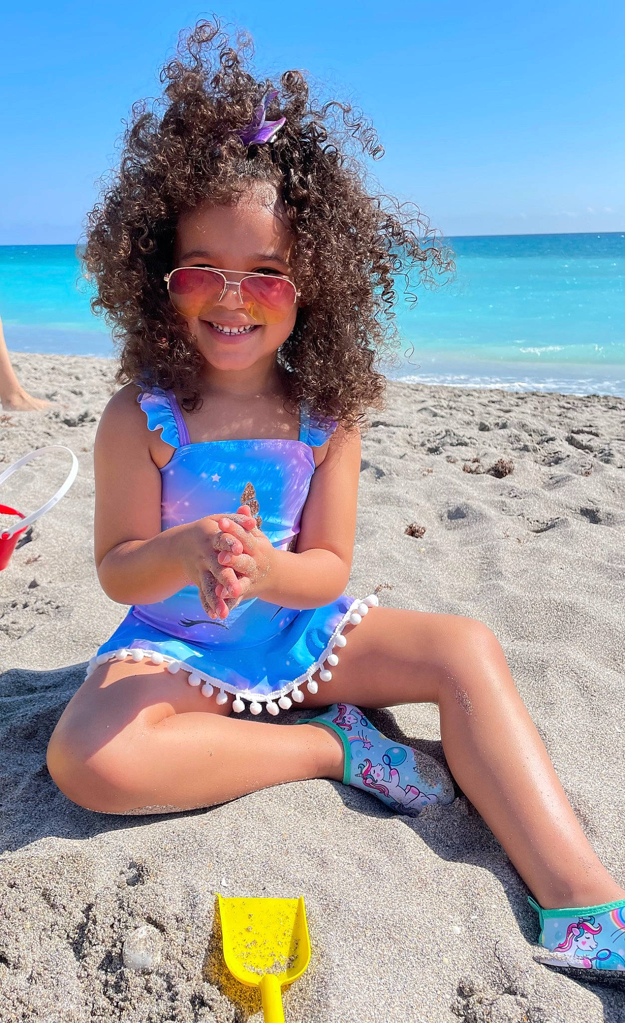 Nadia is registered to the contest to win money with this photo: aqua, azure, beach, blue, dress, face, fun, hairstyle, happy, joy, leisure, people_in_nature, people_on_beach, person, sand, sky, smile, summer, thigh, toddler