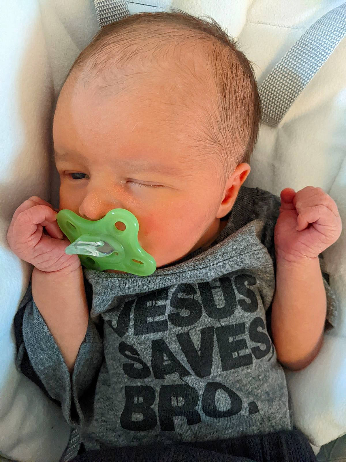 Hudson is registered to the contest to win money with this photo: baby, baby_toddler_clothing, biting, chair, cheek, child, chin, comfort, ear, eye, eyelash, finger, grass, hair, iris, mouth, nose, person, skin, sleeve