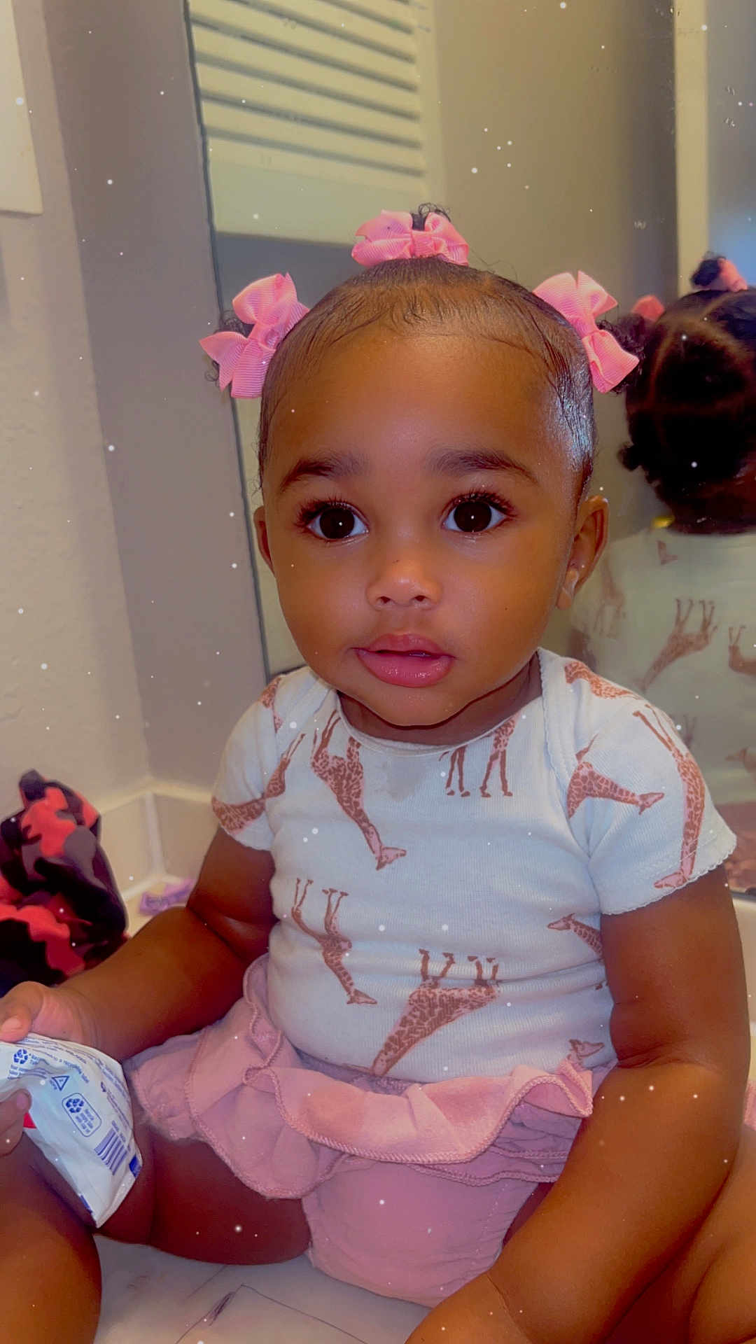 Takala joined the competition — help win amazing prizes! toddler, child, girl, pink_bows, giraffe_print, shirt, skirt, bathroom, mirror, reflection, curly_hair, big_eyes, sitting, holding, countertop, cute, indoor, person, portrait, clothing