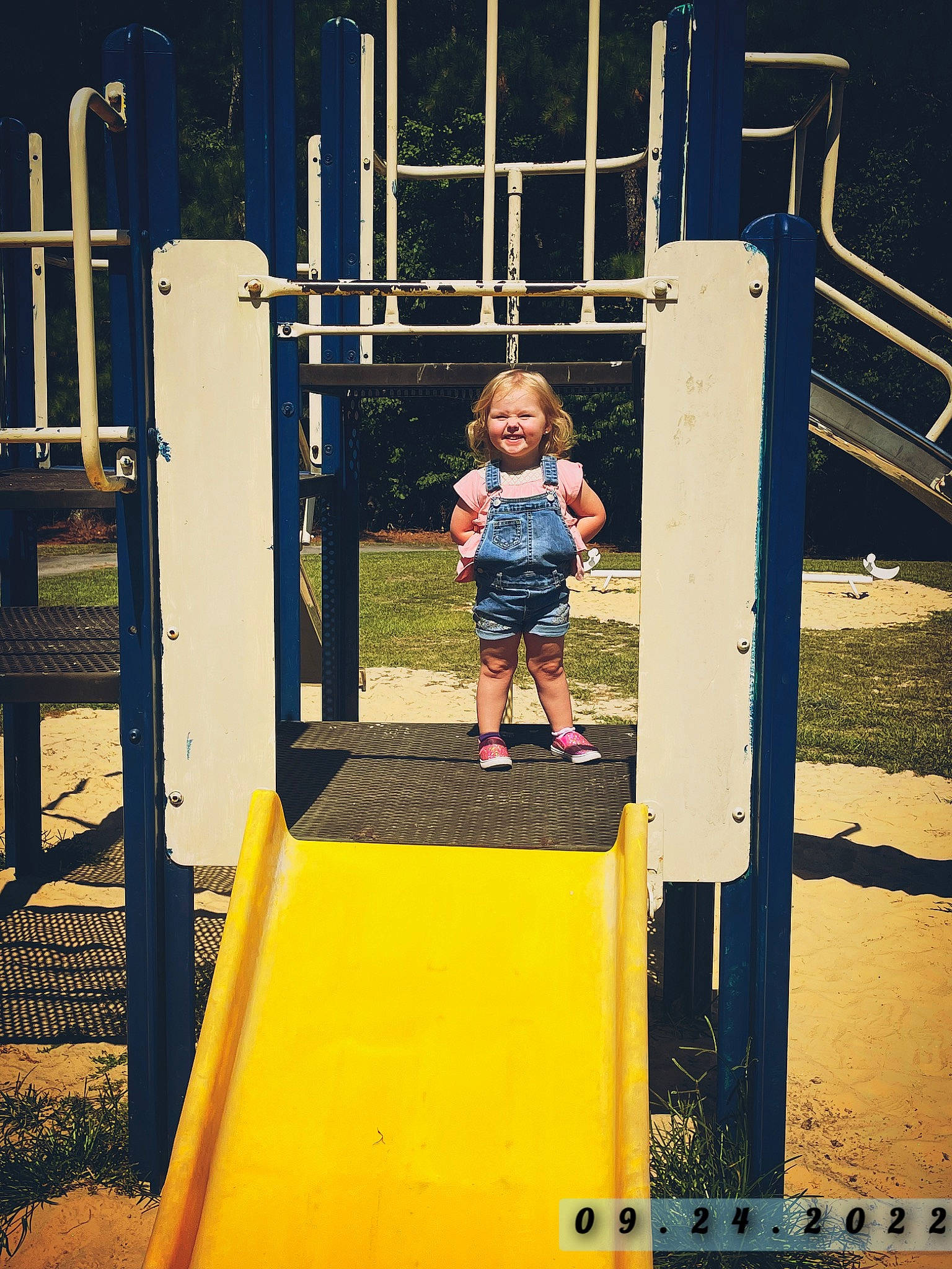 Lilliona joined the competition — help win amazing prizes! baby, child, chute, city, electric_blue, fun, grass, joy, leisure, outdoor_play_equipment, person, play, playground, playground_slide, recreation, shorts, smile, standing, symmetry, t_shirt