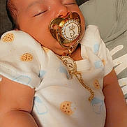 Giovani is registered to the contest to win money with this photo: baby, sleeping, pacifier, onesie, cute, infant, child, resting, peaceful, face, skin, hand, soft, comfort, indoors, portrait, closeup, young, adorable, sleep