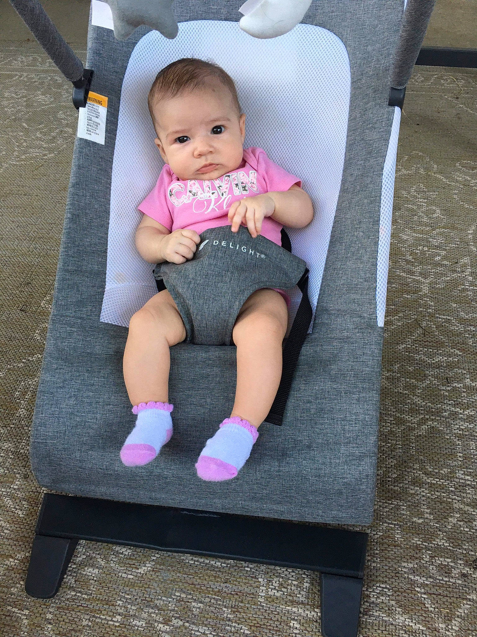 Cali joined the competition — help win amazing prizes! baby, baby_products, baby_toddler_clothing, chair, cheek, child, comfort, flooring, foot, human_leg, knee, lap, leg, magenta, person, product, sitting, sleeve, sock, t_shirt