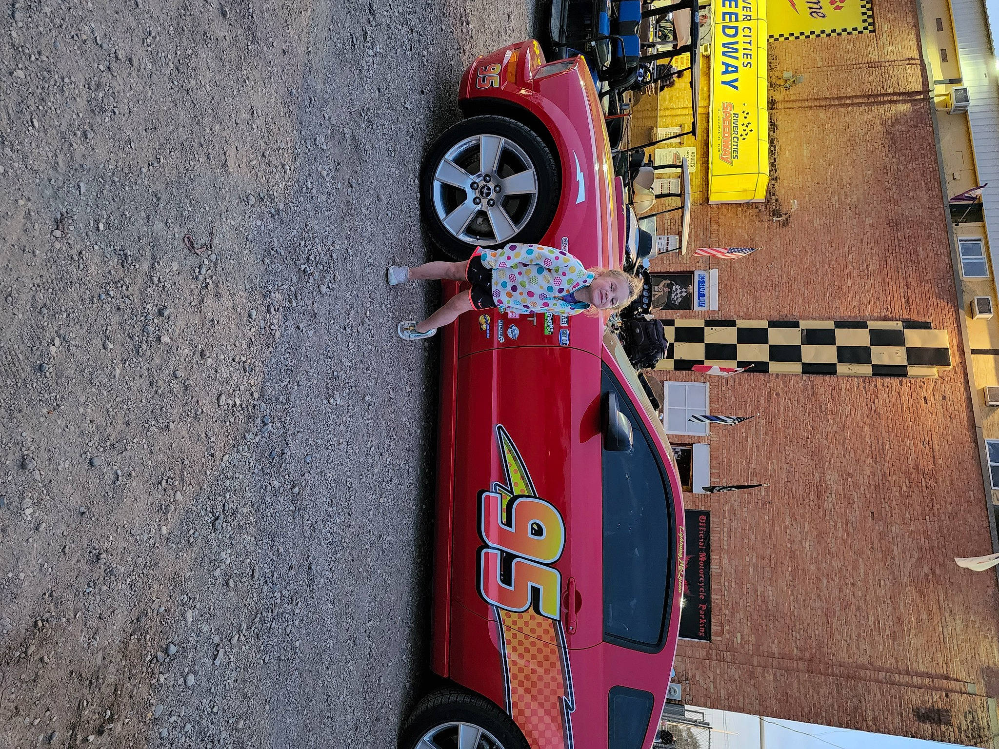 Madilynn joined the competition — help win amazing prizes! asphalt, automotive_design, automotive_exterior, automotive_lighting, automotive_parking_light, automotive_tail_brake_light, automotive_tire, bumper, car, fender, gas, hood, joy, motor_vehicle, person, road_surface, tire, tread, vehicle, vehicle_door