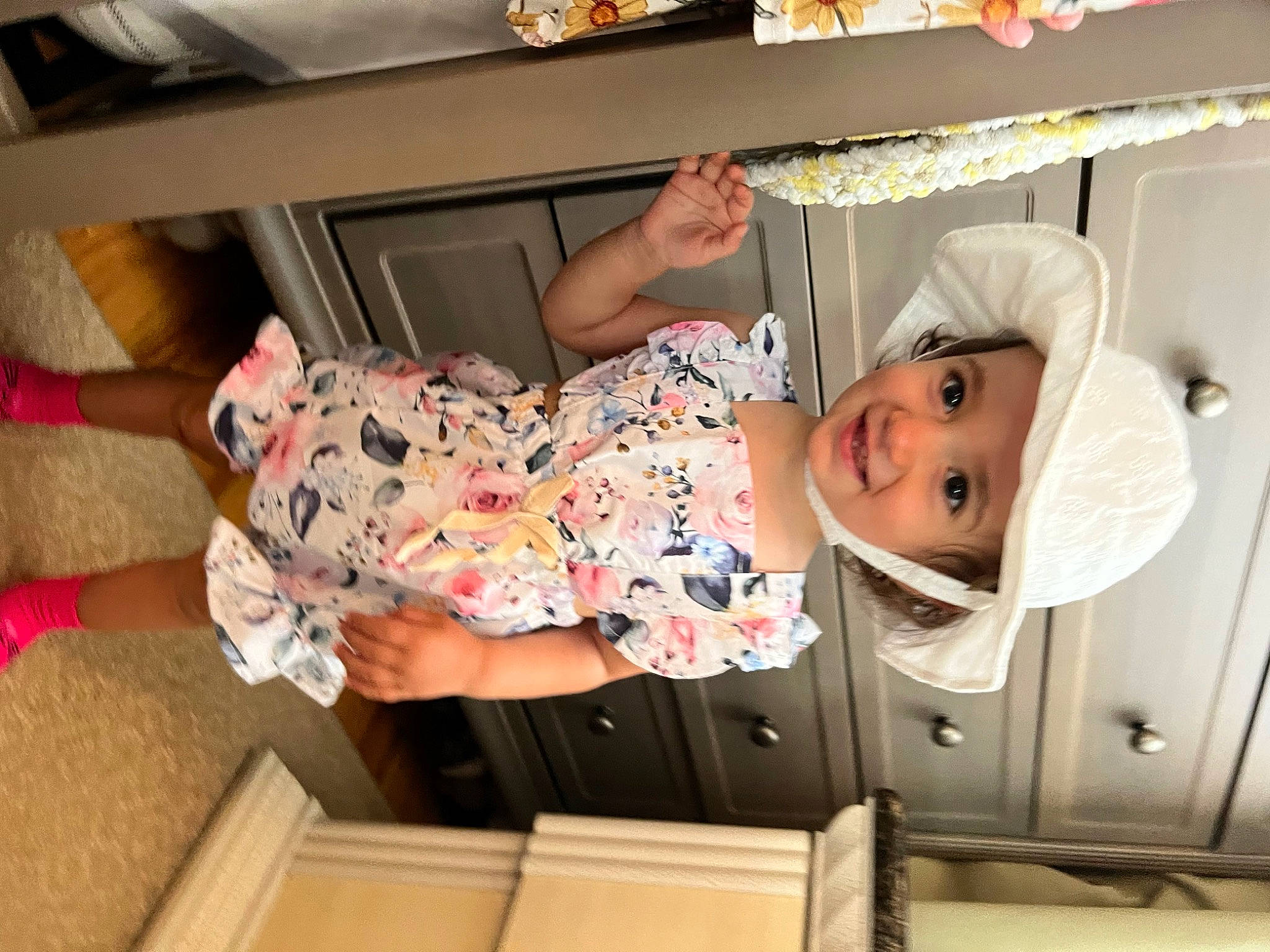 Stella is registered to the contest to win money with this photo: baby, baby_products, baby_safety, baby_toddler_clothing, child, comfort, drawer, fun, hat, headwear, joy, linens, person, pink, product, room, smile, sock, textile, thigh