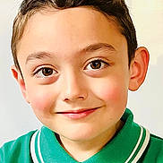 Hunter is registered to the contest to win money with this photo: child, boy, face, smile, eyes, green_shirt, polo_shirt, portrait, close_up, young, cute, happy, casual, childhood, innocent, person, headshot, indoors, light_background, hair