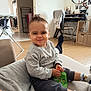 Aaron participe au concours pour gagner de l'argent avec cette photo : toddler, child, indoor, couch, sweatshirt, shorts, socks, toy, playful, face, person, home, floor, chair, desk, photos, mirror, clothing, living_room, expression