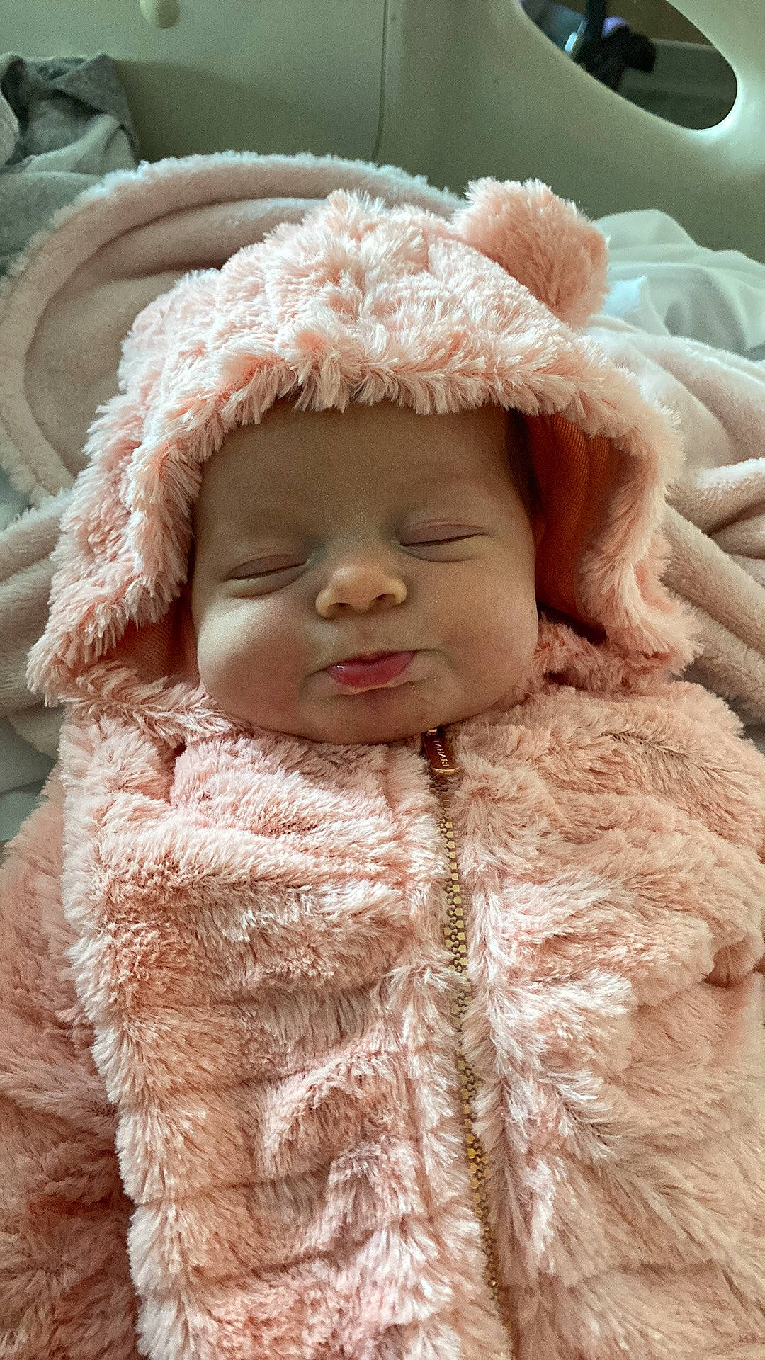 Miley joined the competition — help win amazing prizes! baby_toddler_clothing, cap, cheek, close_up, eye, fur, fur_clothing, happy, head, headgear, human_body, iris, jacket, lip, nose, person, pink, skin, sleeve, toddler