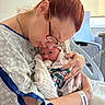 mother, newborn, baby, hospital, hospital_gown, glasses, blanket, nail_art, tattoo, arm_band, bed, chair, intimate, love, family, portrait, indoor, woman, person, infant