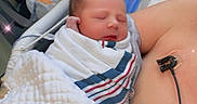 Serenityrose is registered to the contest to win money with this photo: newborn, baby, hospital, blanket, swaddled, sleeping, person, medical_equipment, chest, skin, chair, phone, bag, sparkles, closeup, indoor, comfort, rest, tenderness, care