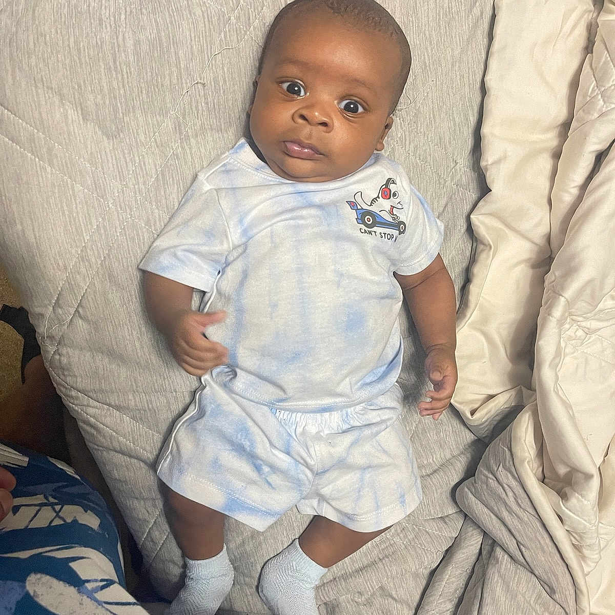Legend is registered to the contest to win money with this photo: baby, bed, clothing, couch, cushion, face, furniture, head, homedecor, hosiery, linen, pants, person, photography, portrait, shorts, sitting, sock, standing, t_shirt