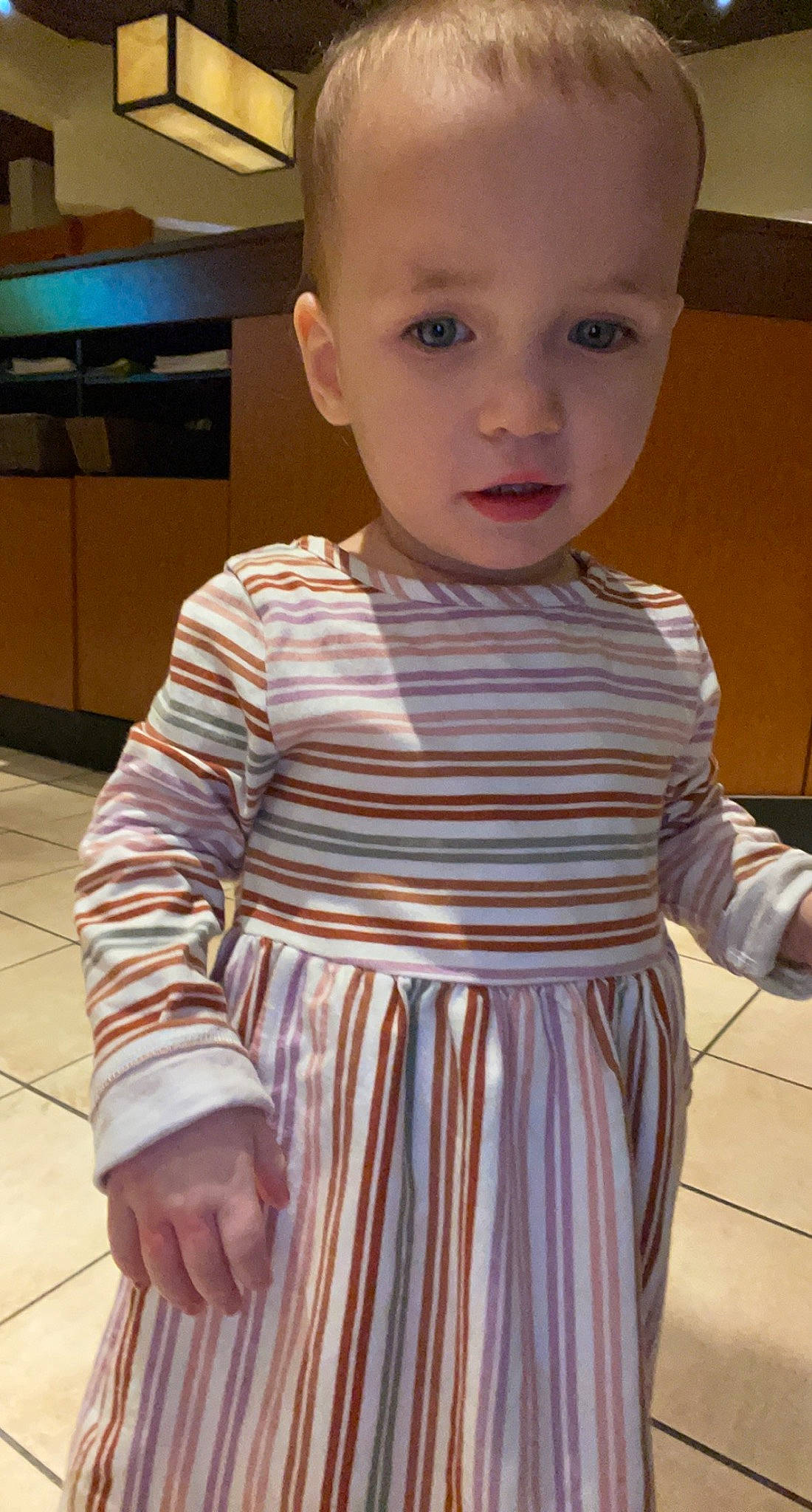 Sofia is registered to the contest to win money with this photo: baby, baby_toddler_clothing, cheek, child, chin, day_dress, dress_shirt, fashion_design, flooring, formal_wear, iris, kitchen_appliance, neck, pattern, person, shoulder, skin, sleeve, standing, t_shirt