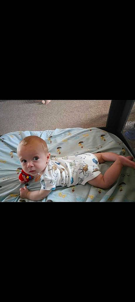 Briar is registered to the contest to win money with this photo: baby, baby_products, baby_toddler_clothing, cheek, child, comfort, flash_photography, happy, linens, pattern, person, photo_caption, portrait_photography, room, sitting, skin, sleeve, t_shirt, toddler, wood