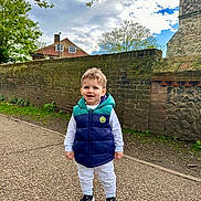 Teo is registered to the contest to win money with this photo: architecture, boy, building, castle, child, clothing, coat, face, fortress, head, jacket, male, outdoors, pants, person, photography, portrait, standing, walking, wall