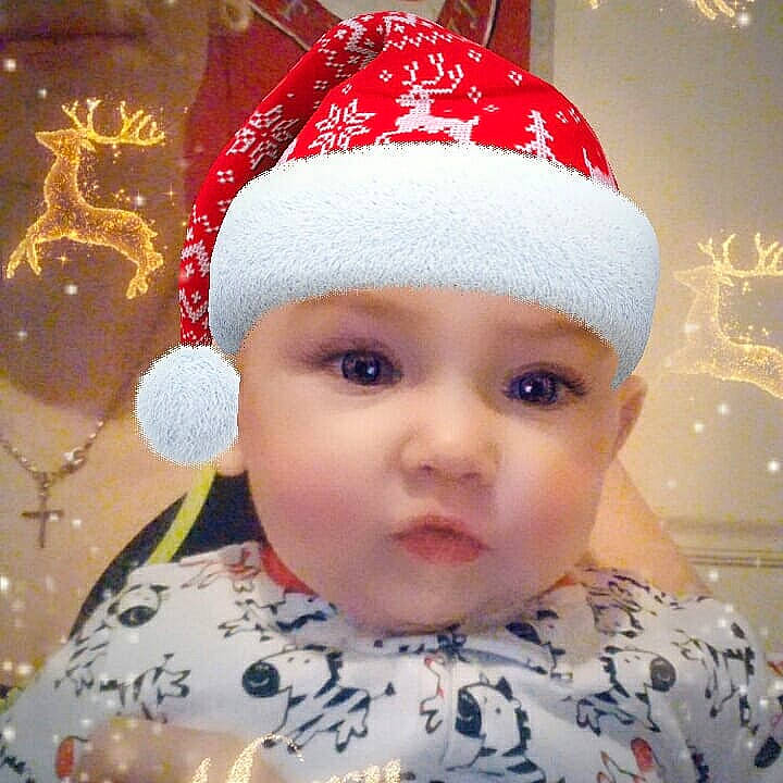 Kinsley is registered to the contest to win money with this photo: beanie, bonnet, cap, cheek, child, christmas, christmas_ornament, hair_accessory, hat, head, headgear, holiday, infant, knit_cap, lip, nose, person, product, smile, toddler