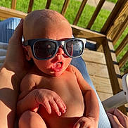 Kingston joined the competition — help win amazing prizes! baby, sunglasses, infant, hand, foot, skin, outdoor, sunlight, wooden_deck, diaper, person, human, relaxing, cute, expression, summer, shadows, closeup, casual, holding