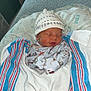 Kingston is registered to the contest to win money with this photo: newborn, baby, sleeping, hat, pajamas, blanket, swaddled, indoor, cozy, infant, bedroom, soft, cute, resting, child, person, face, hospital, window, lighting
