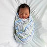 baby, bed, blanket, child, cozy, cute, human, indoors, infant, newborn, peaceful, portrait, resting, sleeping, soft, striped, swaddled, white, wrapped, young