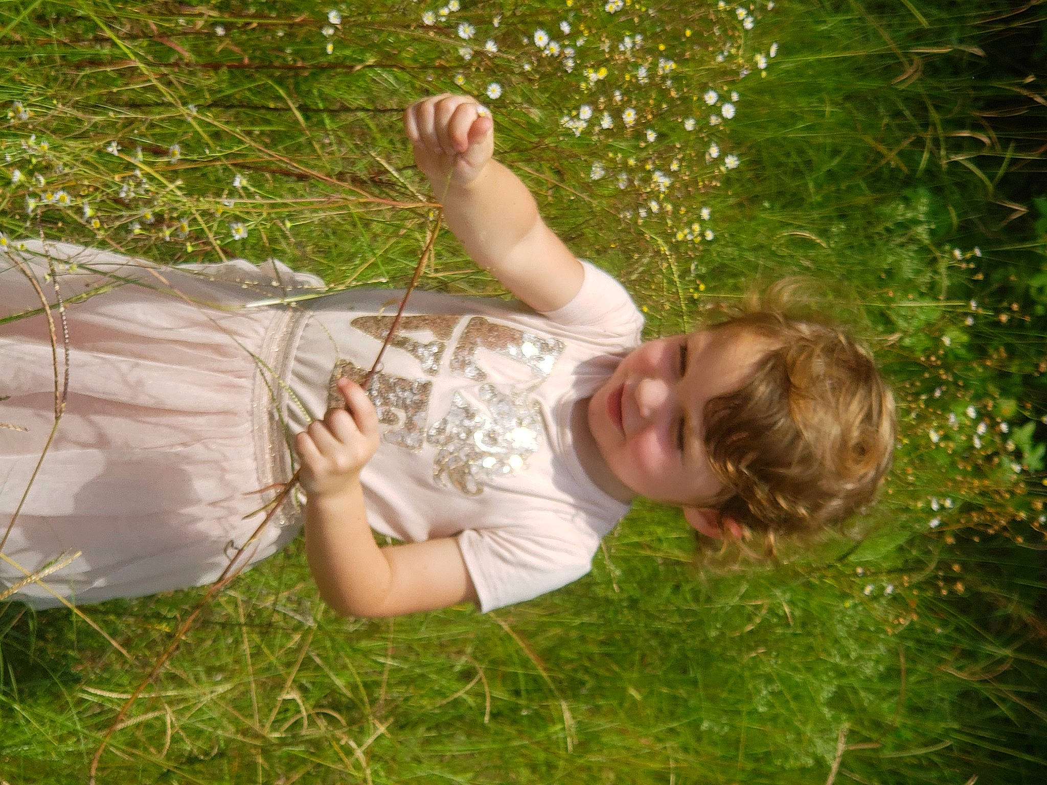 Caitlyn joined the competition — help win amazing prizes! fawn, finger, fun, gesture, grass, grass_family, grassland, hand, happy, joy, lawn, leisure, meadow, people_in_nature, person, plant, smile, sunlight, toddler, tree