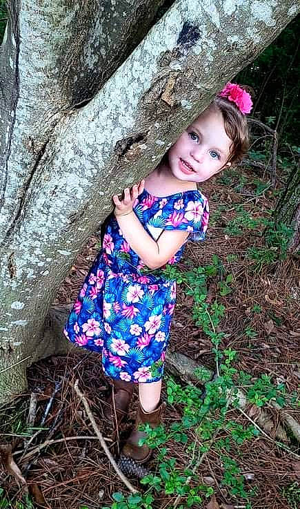 Caitlyn joined the competition — help win amazing prizes! botany, branch, eye, face, facial_expression, grass, happy, leaf, natural_environment, nature, organ, people_in_nature, person, photograph, pink, plant, skin, smile, toddler, tree