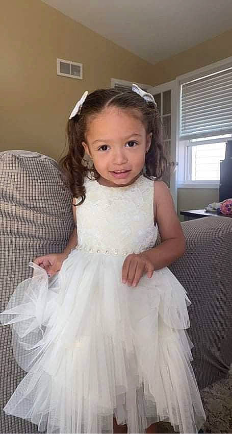 Maliyah is registered to the contest to win money with this photo: arm, bridal_party_dress, dress, face, flash_photography, hair, hairstyle, happy, head, human_body, joy, neck, one_piece_garment, person, shoulder, skin, smile, standing, wedding_dress, white