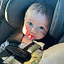 baby, car_seat, child, face, infant, seatbelt, straps, pacifier, clothing, hand, sunlight, closeup, cute, expression, indoors, person, safety, head_support, young, portrait