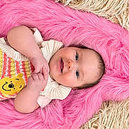 Kalea joined the competition — help win amazing prizes! baby, infant, child, smiling, lying_down, portrait, face, eyes, hands, knitted_clothing, yellow_character, pink_blanket, furry_blanket, beige_blanket, textile, indoor, close_up, happy, adorable, photography